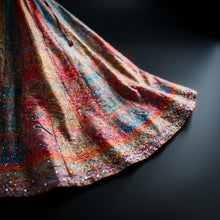Load image into Gallery viewer, Produce a close-up, studio-quality shot of the 'NINA SKIRT' focusing on the detailed encrusted crystals and rich fabric texture. Use rim lighting to create a dramatic highlight along the edges of the skirt, capturing the intricate beadwork and the luxuriou